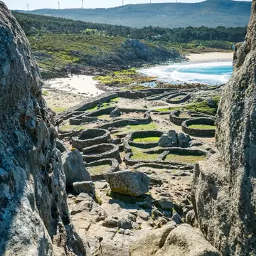 View of the ruins of the prehistoric settlement of Castro de Baroña in the Rías Baixas, Spain.