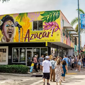 Miami, United States - March 21, 2016: Tourists stand to order from the open air countertop of a restaurant advertising Cuban food and drinks on historic Calle Ocho in Little Havana.