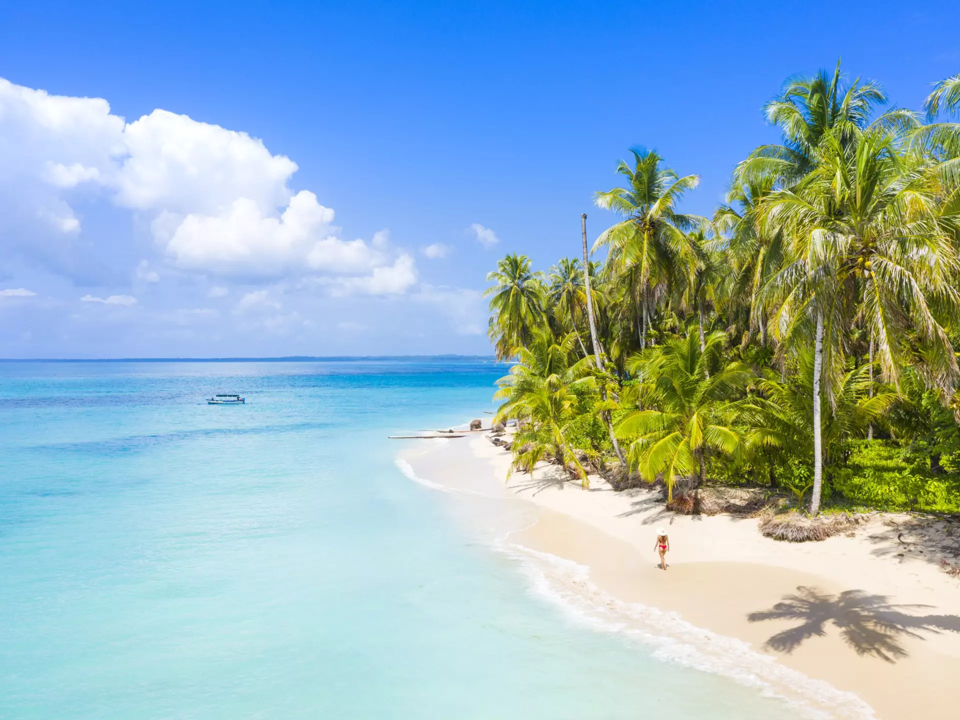 Woman walking on the beach in the Bocas del Toro islands. Zapatilla island, Panama