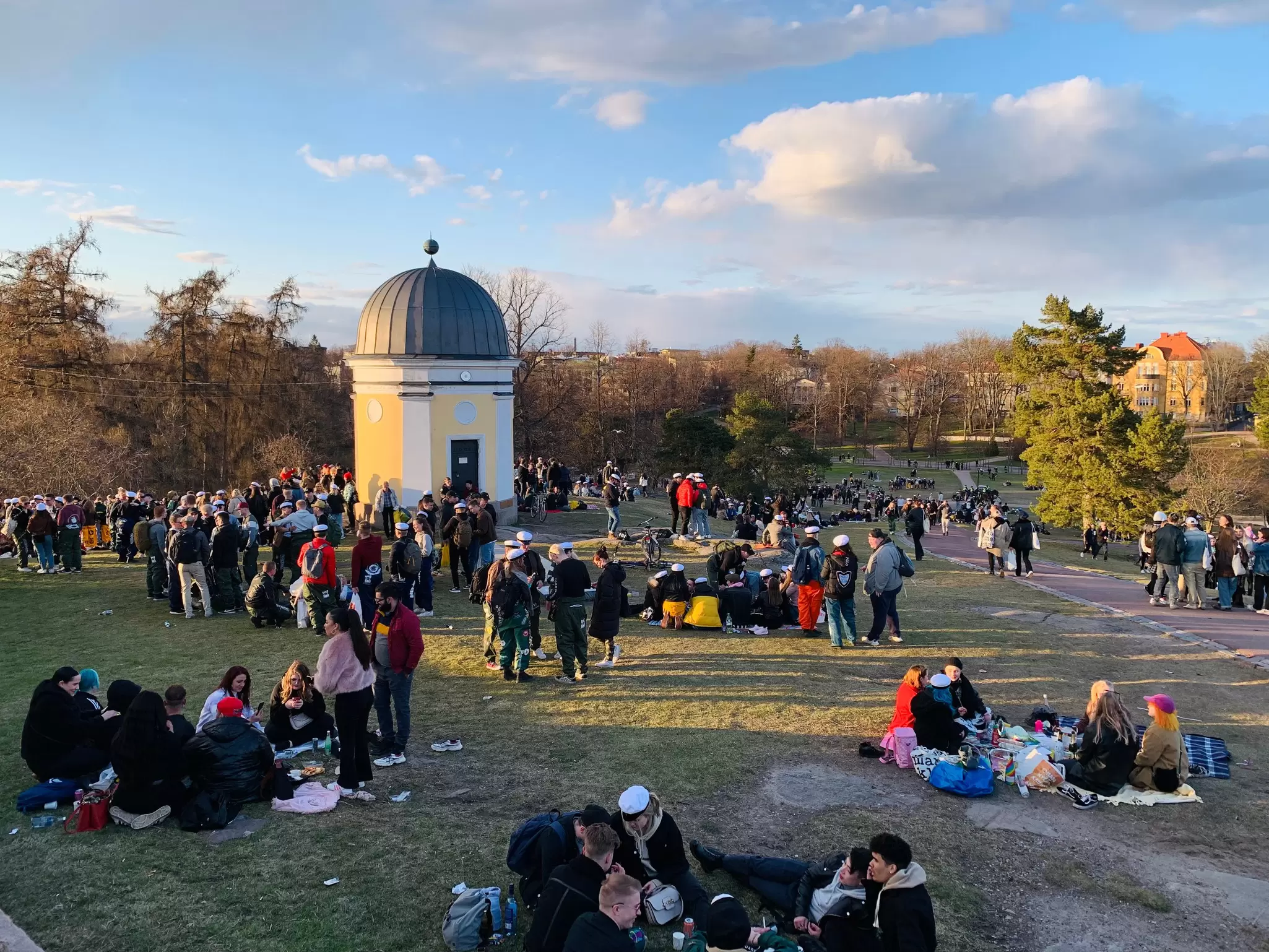 Helsinki, Finland - April 30, 2021: Vappu May Day celebration in Kaivopuisto park in Helsinki, Finland. People sitting in the park and enjoying spring holiday.  License Type: media  Download Time: 2023-03-16T19:26:00.000Z  User: Norma.PrauseBrewer_LonelyPlanet  Is Editorial: Yes  purchase_order:   