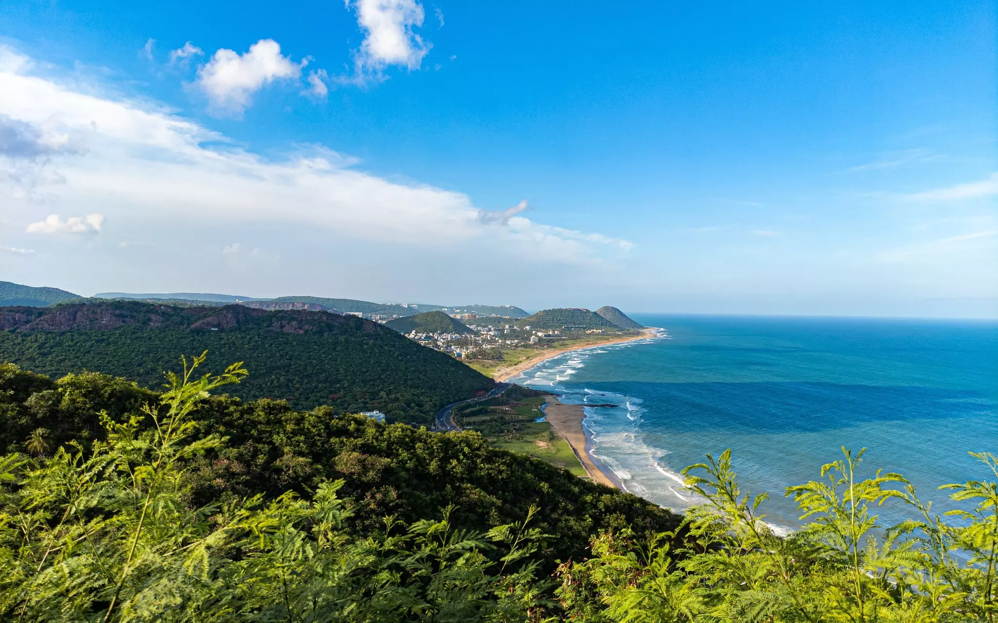 A hilltop view of hills and the coastline at Visakhapatnam.