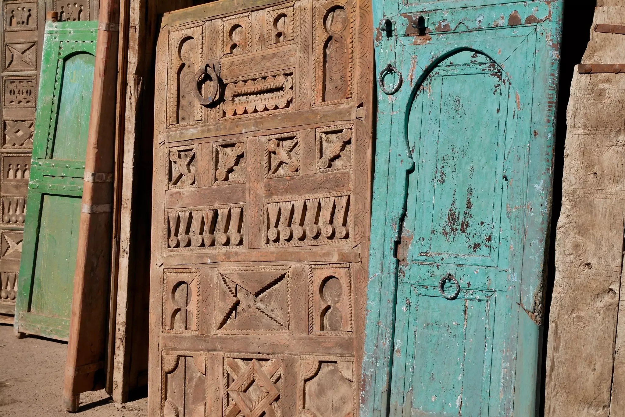 Beautiful old wooden doors on display for sale at Bab el Khemis flea market. Marrakech, Morocco