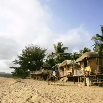 Beach huts on Agonda Beach on a sunny day