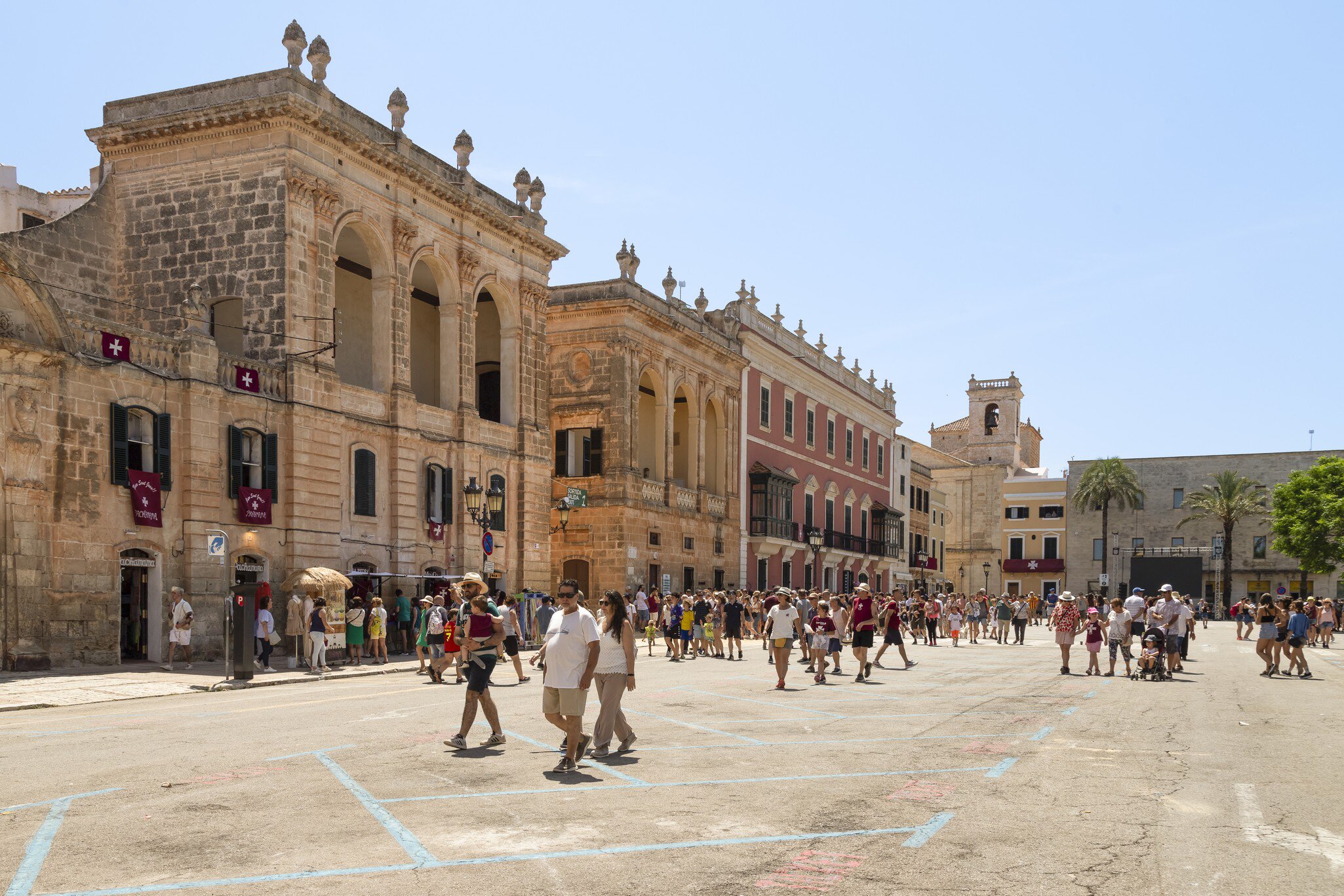 People walk across the Plaça des Born in the historic Ciutadella in Menorca, Spain.