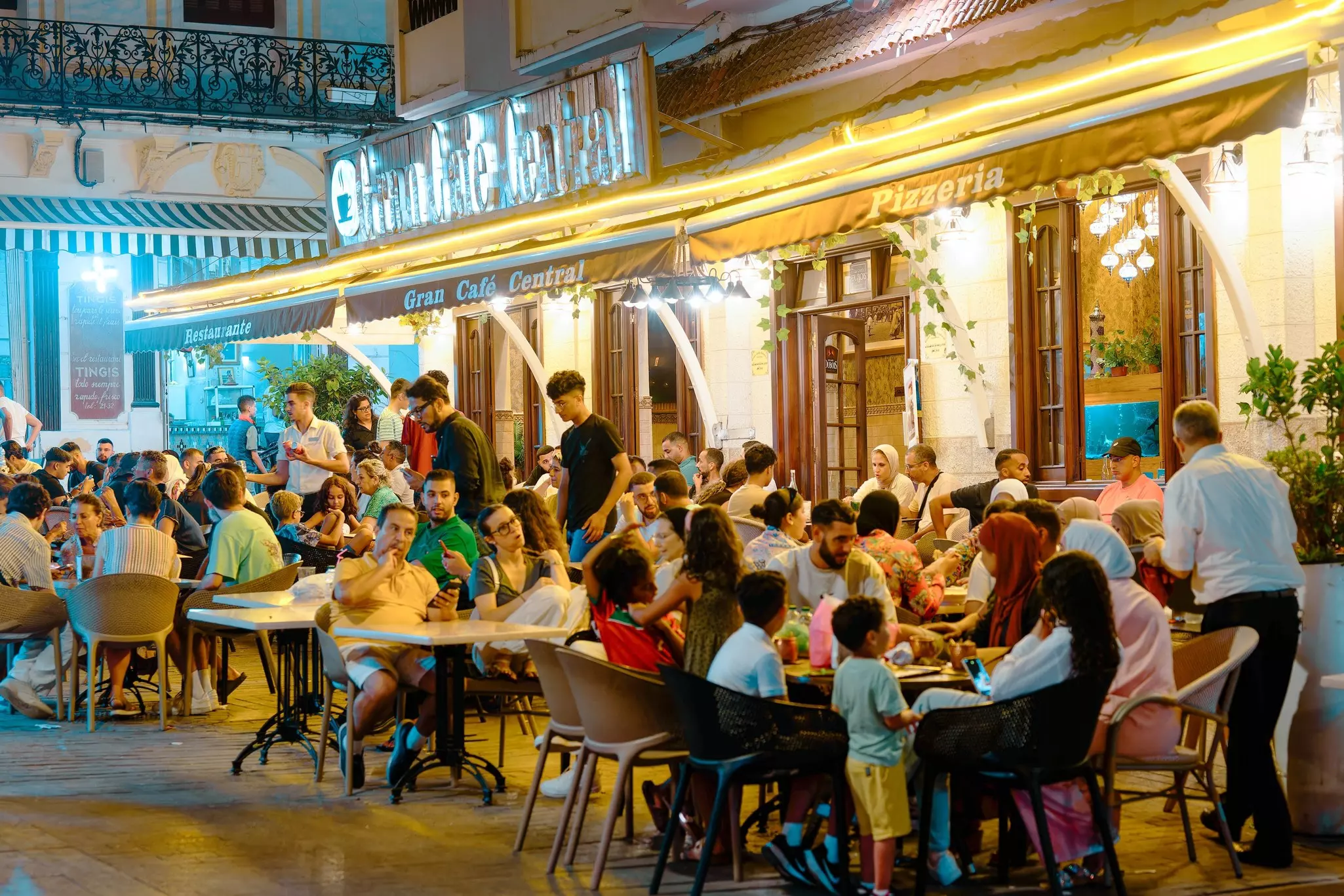 People dining outside at night in Petit Socco