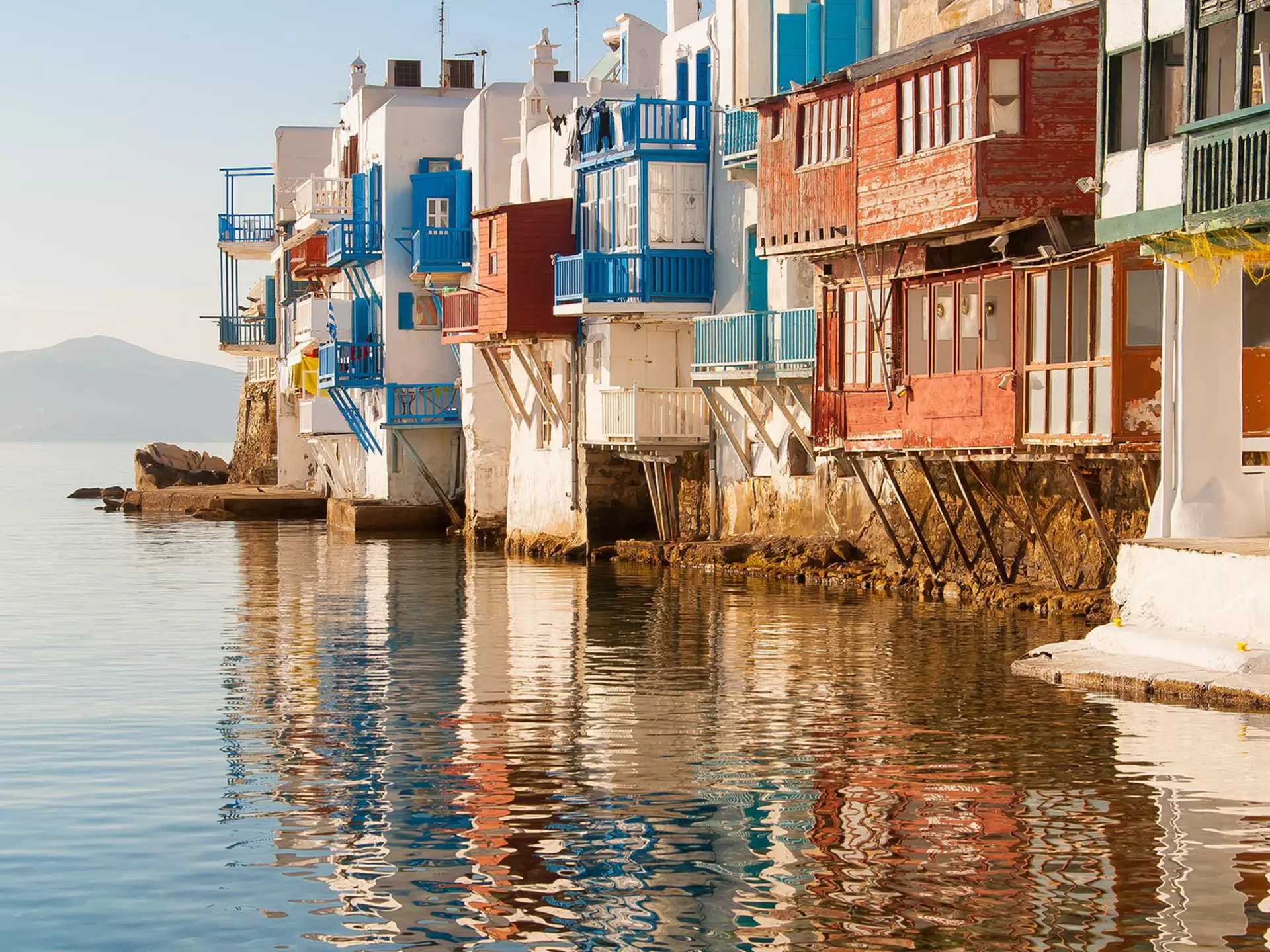Little Venice buildings overlooking the water at sunset on Mykonos Island in the Mediterranean Sea. Greece.