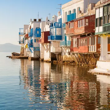 Little Venice buildings overlooking the water at sunset on Mykonos Island in the Mediterranean Sea. Greece.