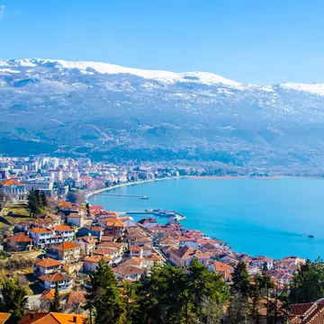 Snowy mountains rise above Lake Ohrid in North Macedonia.