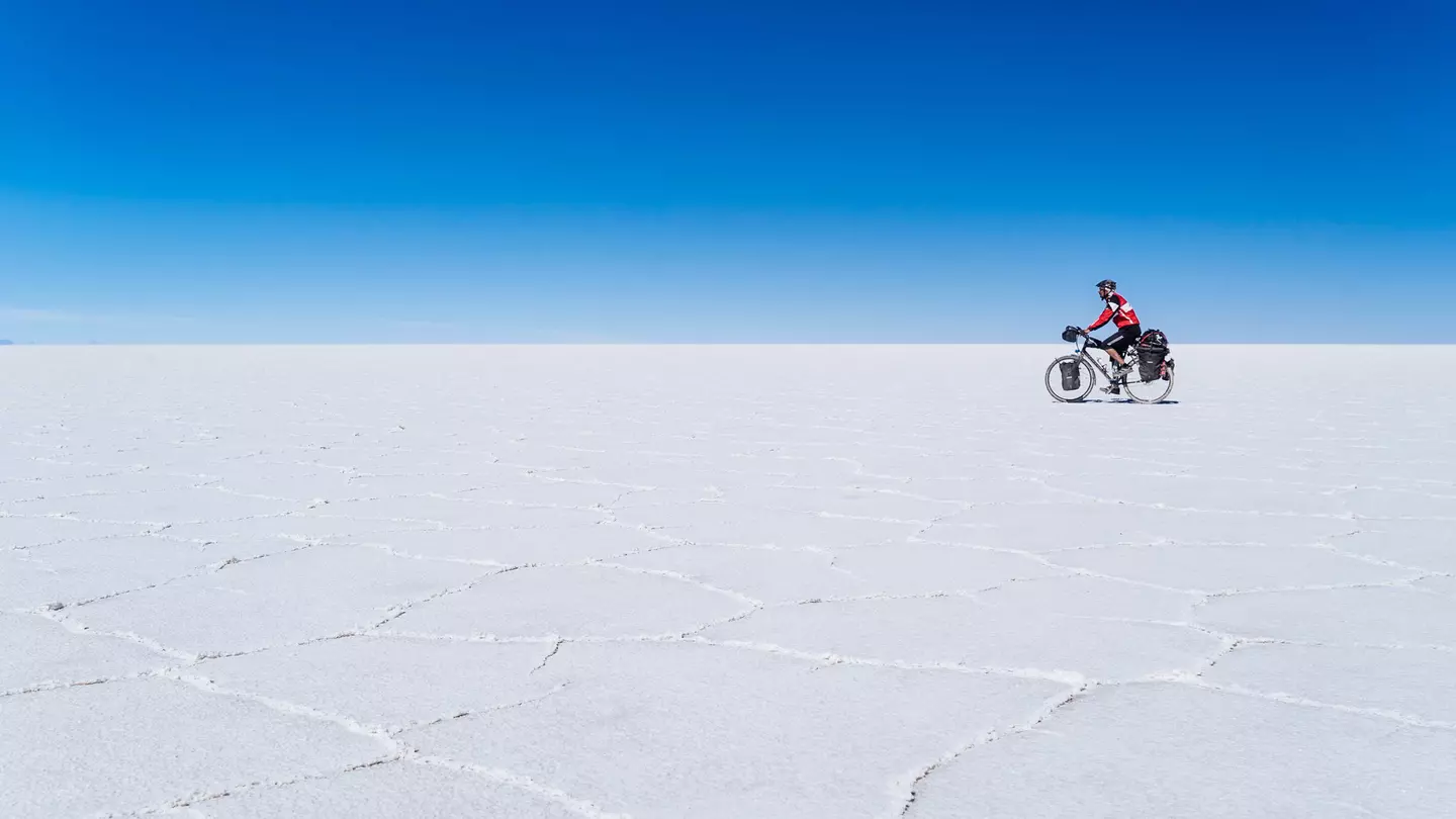 A long-distance cyclist passing through the Salar De Uyuni
