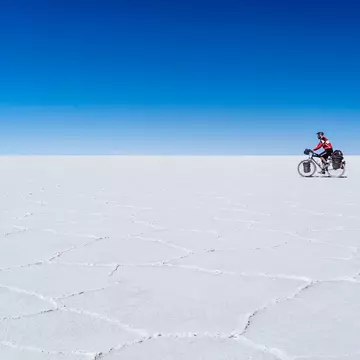 A long-distance cyclist passing through the Salar De Uyuni