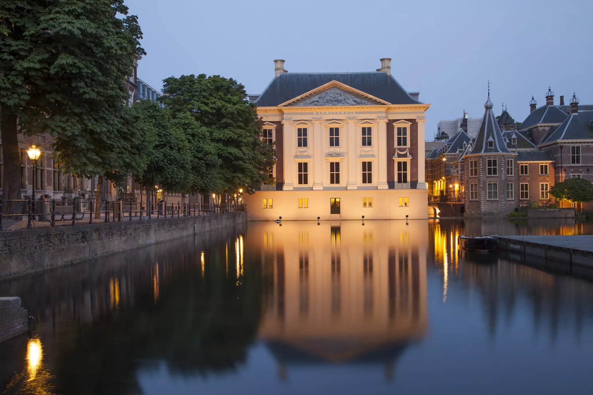 The Mauritshuis Museum at night with the museum's lights reflecting off the local water