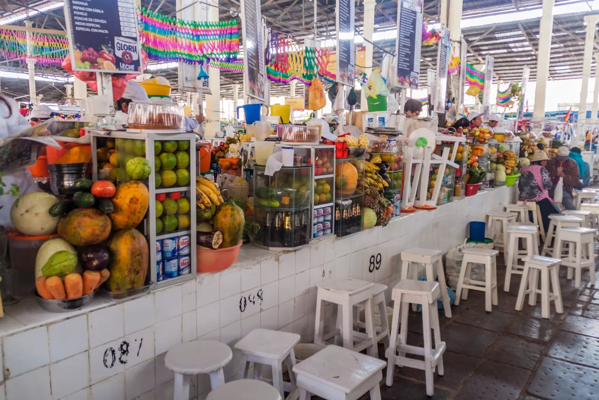 Fruit juice stalls in Mercado San Pedro market in Cuzco, Peru