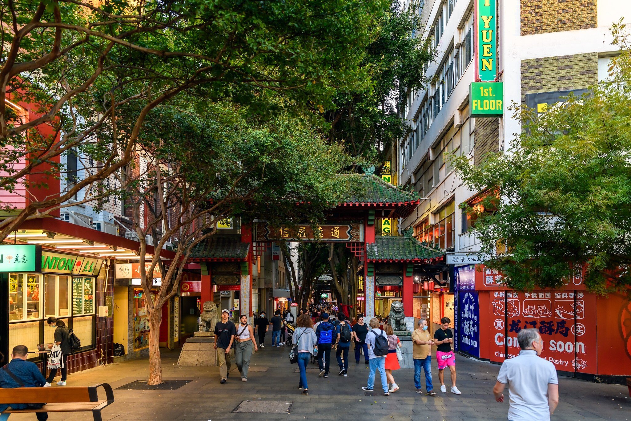Chinatown main entrance with people walking by during evening time in Sydney, Australia.