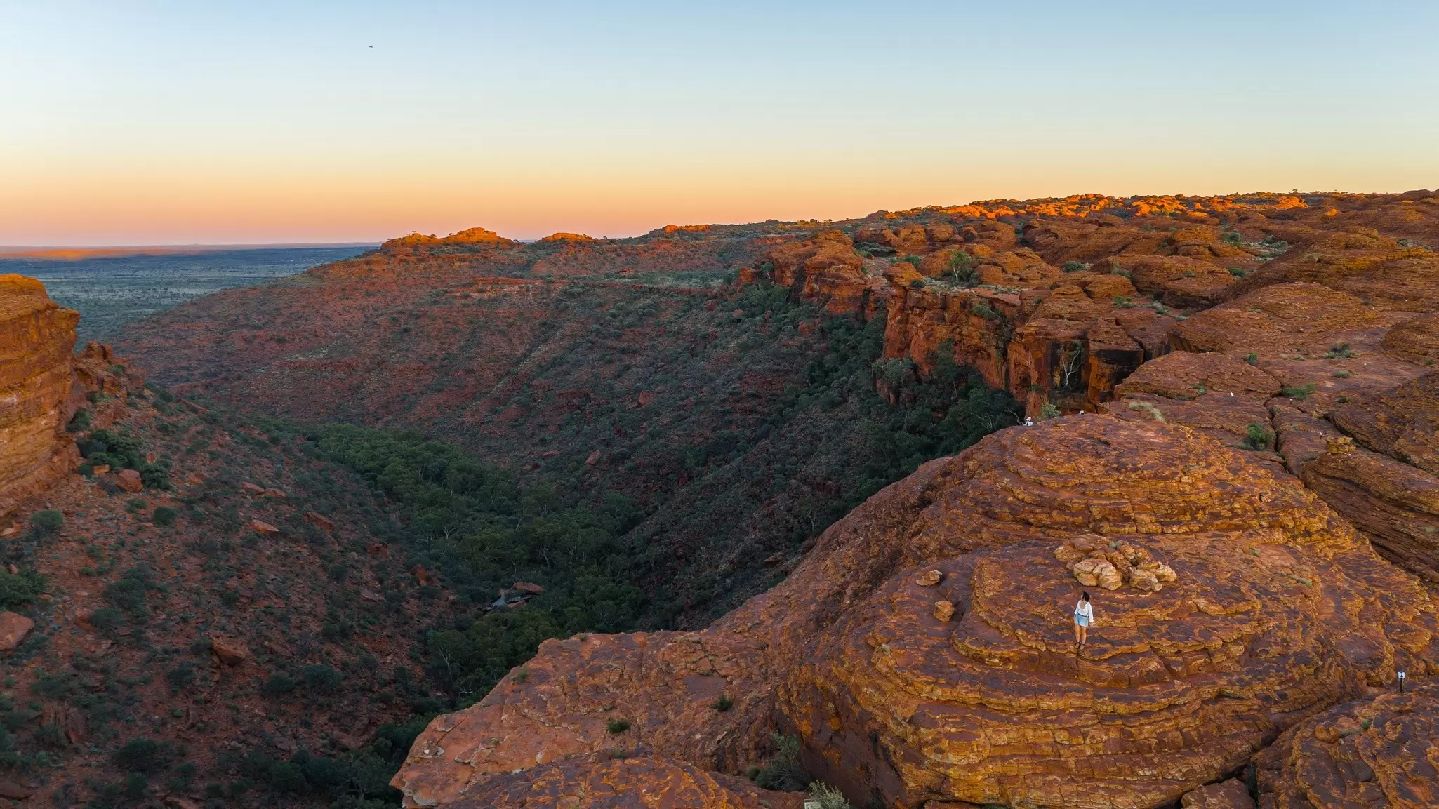 Kings Canyon Rim Walk from above with one walker in white a small figure on the cliff
