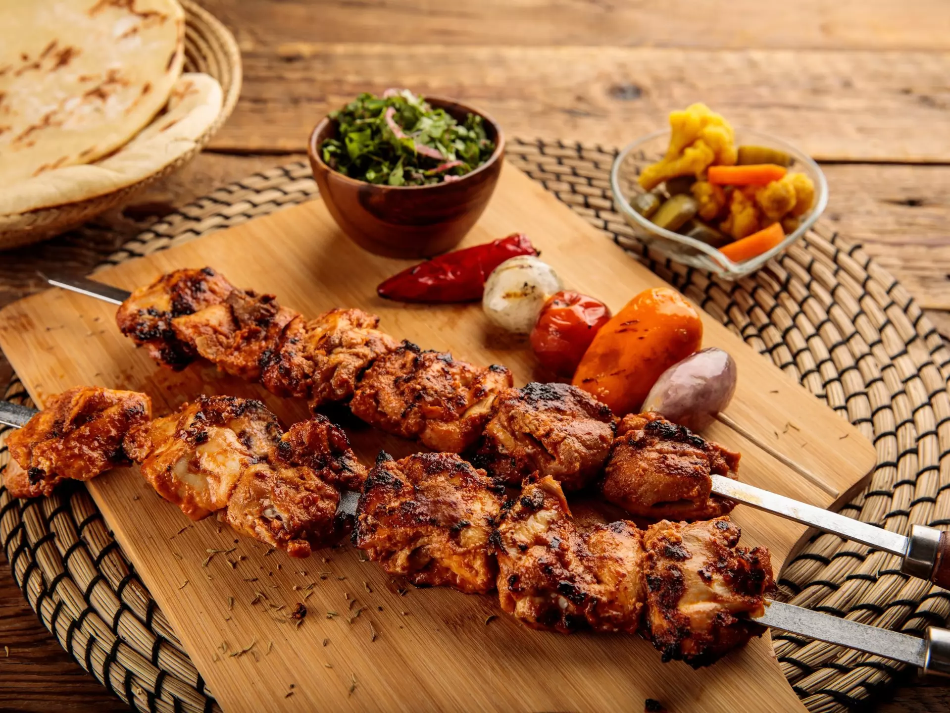Shish Tawook kebab with pickle and bread served in a dish isolated on wooden background side view, License Type: media, Download Time: 2024-07-29T17:39:48.000Z, User: nic.dhoedt_lonelyplanet, Editorial: false, purchase_order: 56530, job: Global Publishing WIP, client: Lonely PlanetMiddle East 10, other: Nicolas D'Hoedt