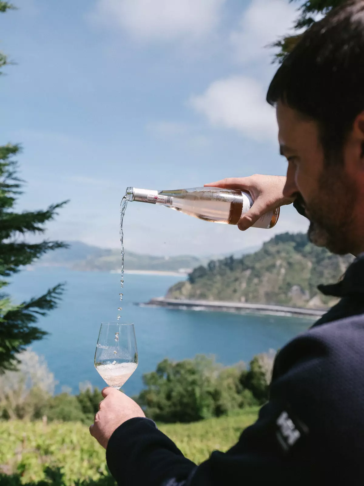 Pouring a glass at Txomin Etxaniz Winery.