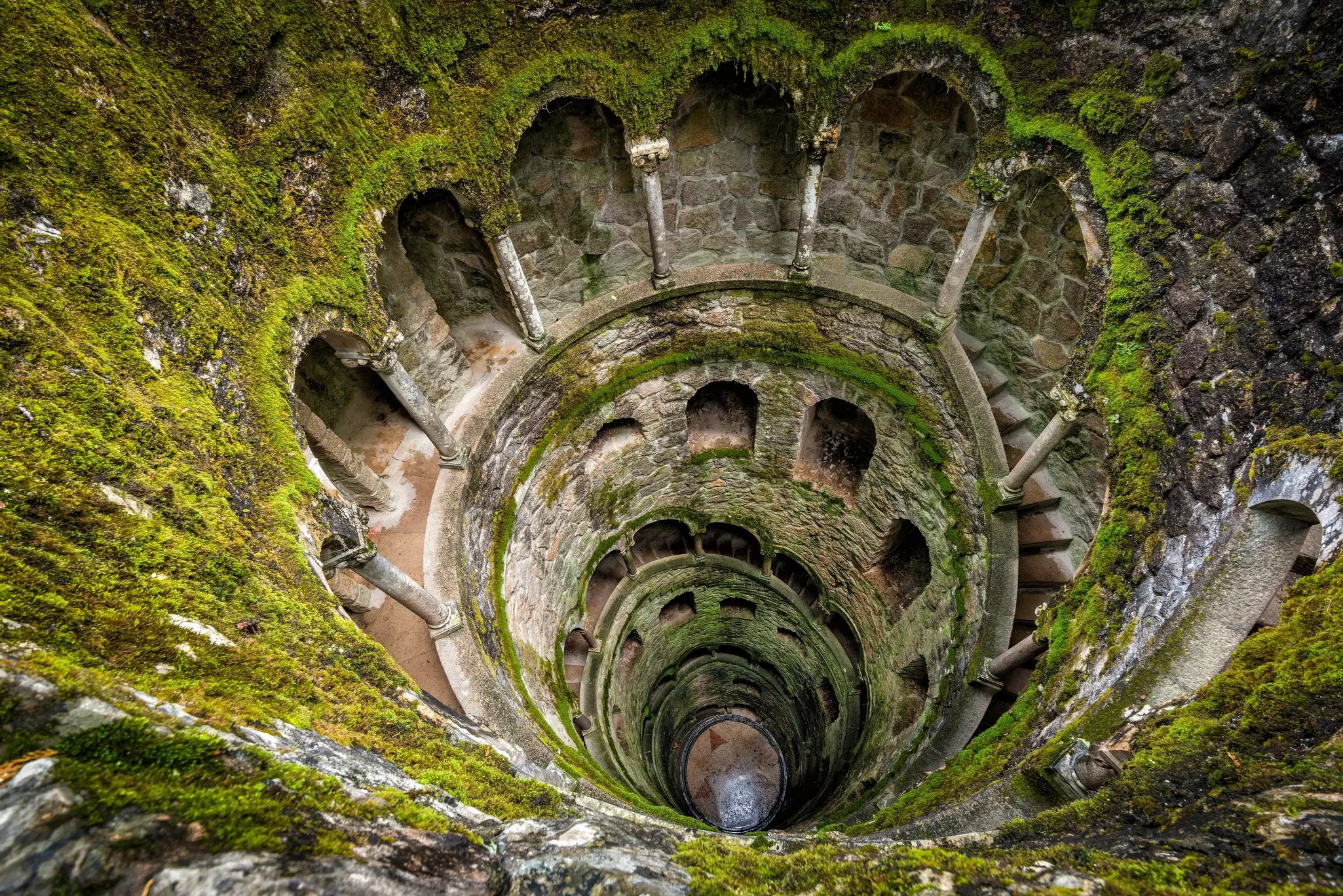 An inverted tower built into the ground resembling a well but with a stepped walkway surrounding the edge