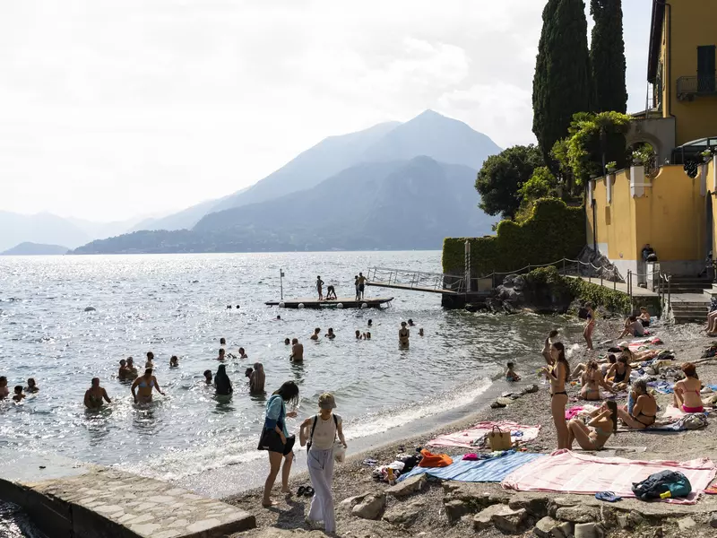 Beachgoers swimming in a lake