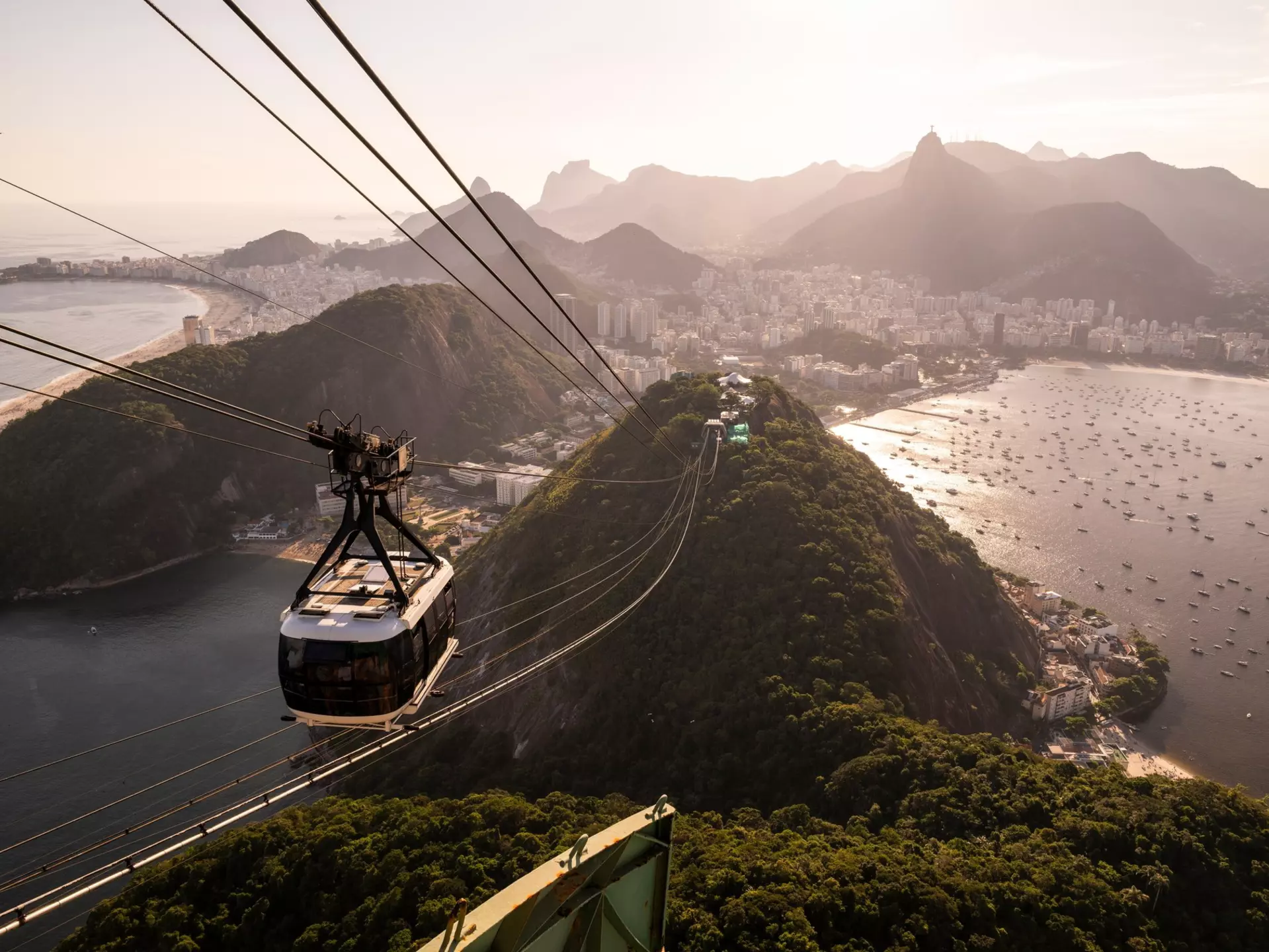 Beautiful view to Sugar Loaf mountain cable car, city and ocean in Rio de Janeiro, Brazil. 
