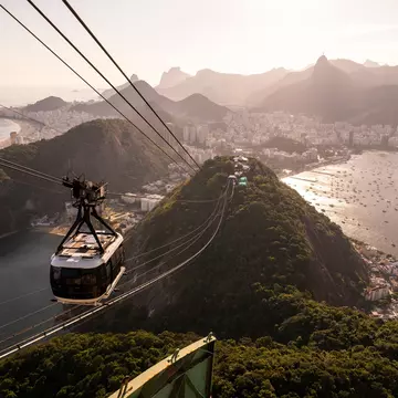 Beautiful view to Sugar Loaf mountain cable car, city and ocean in Rio de Janeiro, Brazil. 