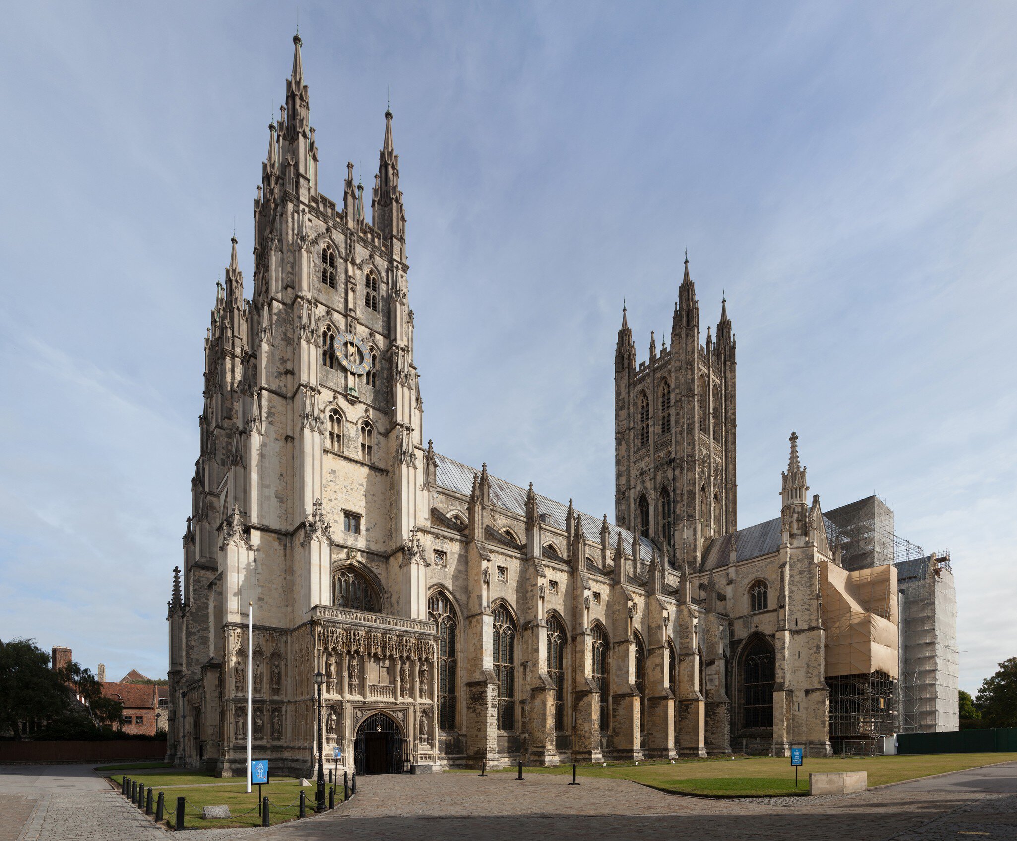 The Gothic west front and central tower of a stone cathedral.