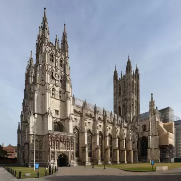 The Gothic west front and central tower of a stone cathedral.