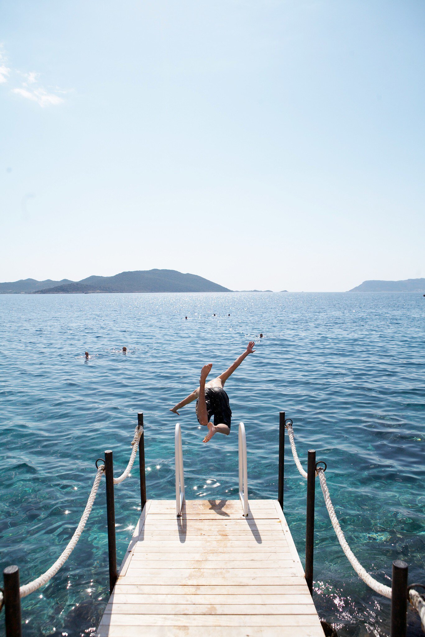 Boy diving off jetty.