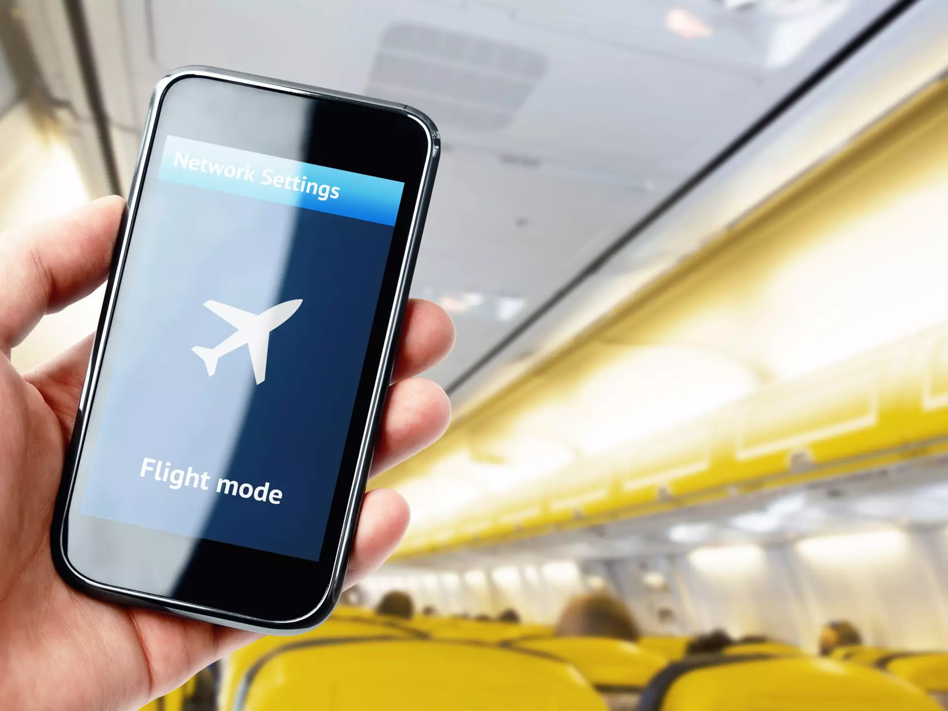 Interference from phones with plane equipment is rare, but can happen. pabmap / Shutterstock