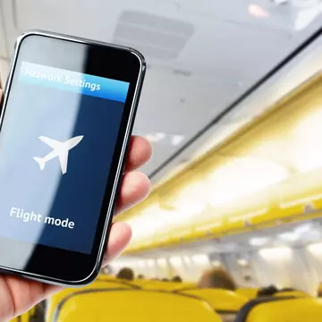 Interference from phones with plane equipment is rare, but can happen. pabmap / Shutterstock