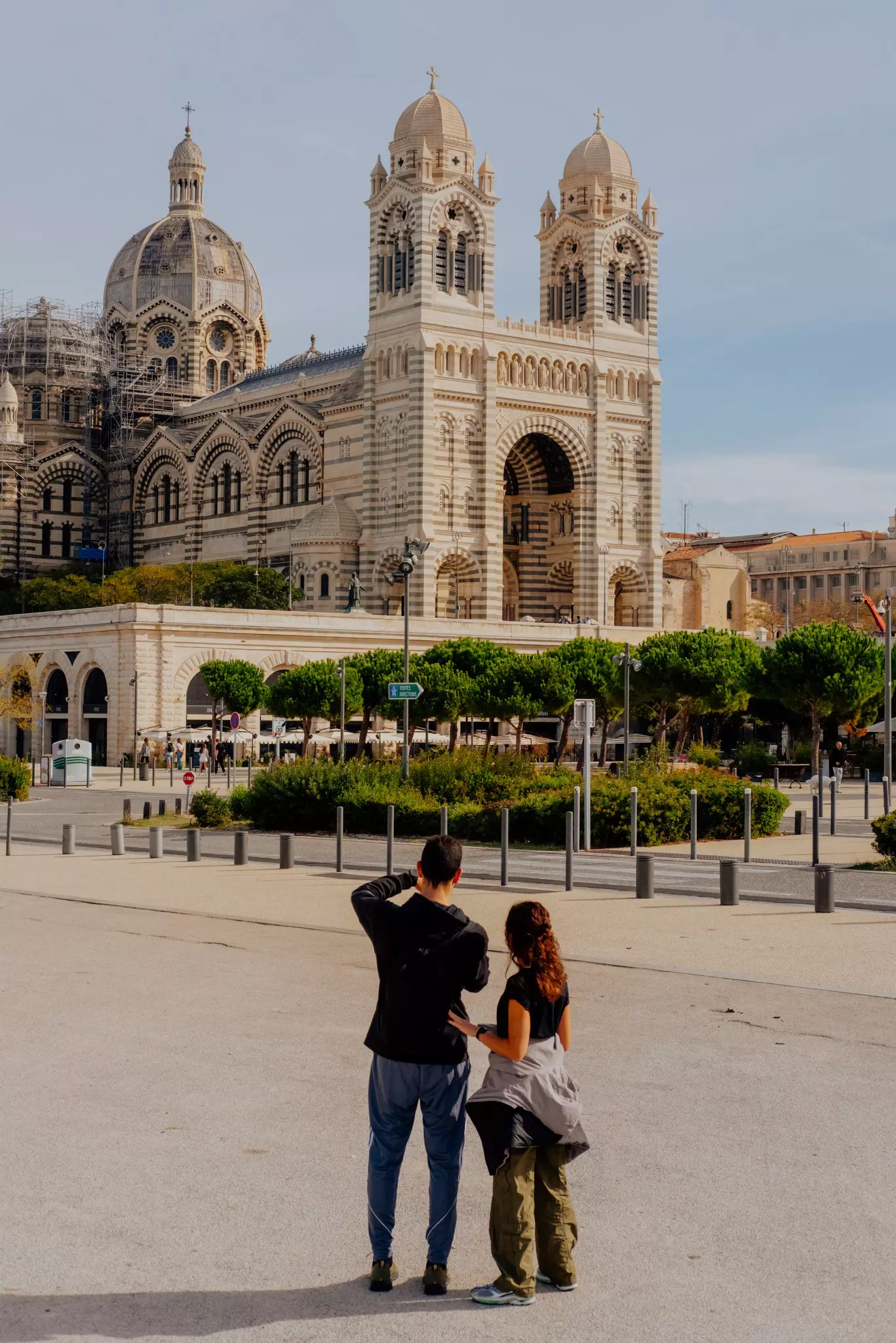 A child and adult look at a large cathedral. 