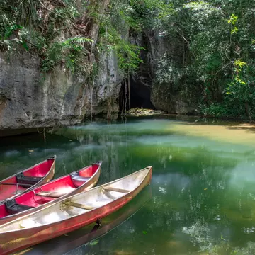 Canoes at the entrance to Barton Creek Cave in the Cayo District of Belize.