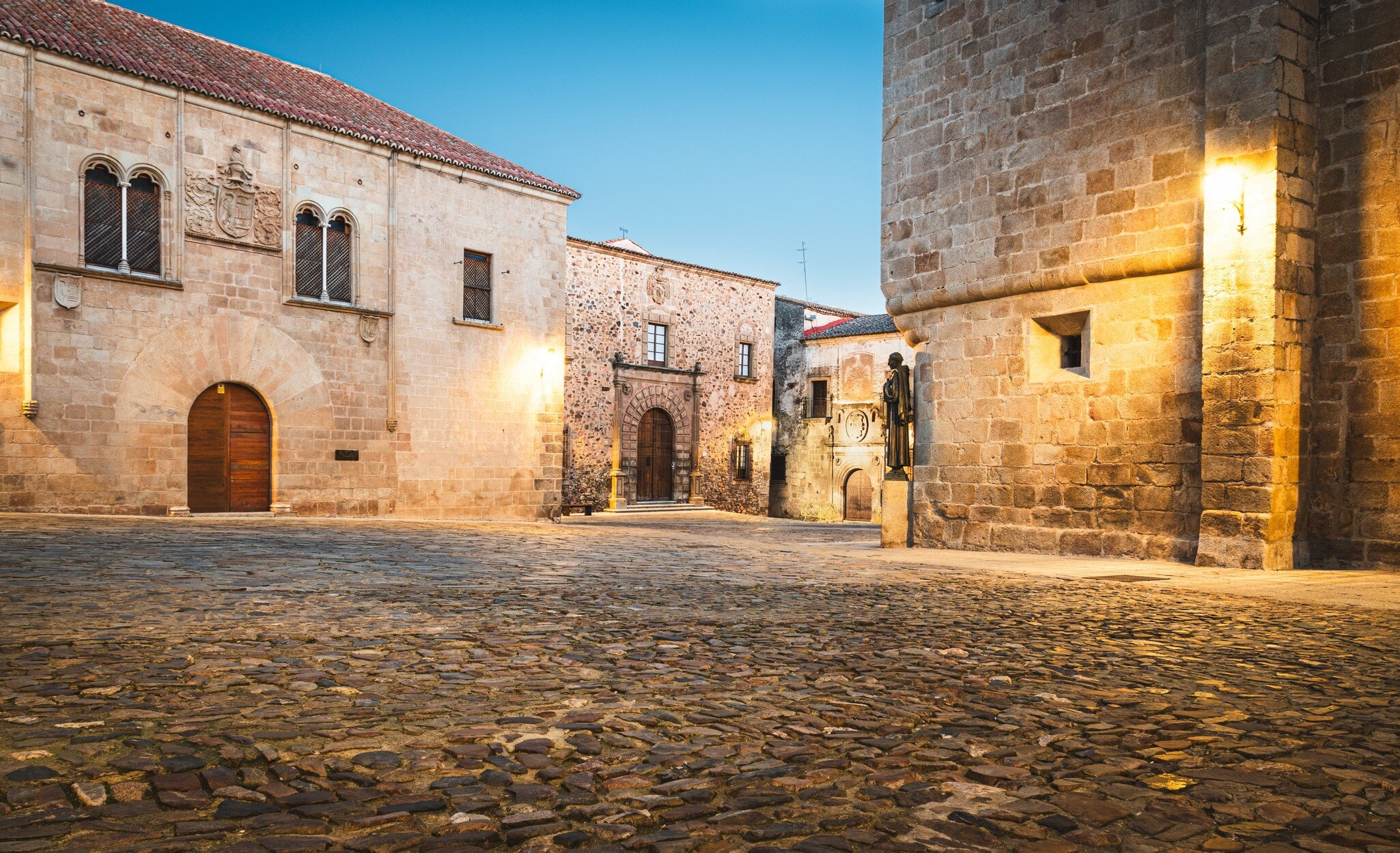 View of stone buildings in the Plaza de Santa María in Cáceres, Spain.