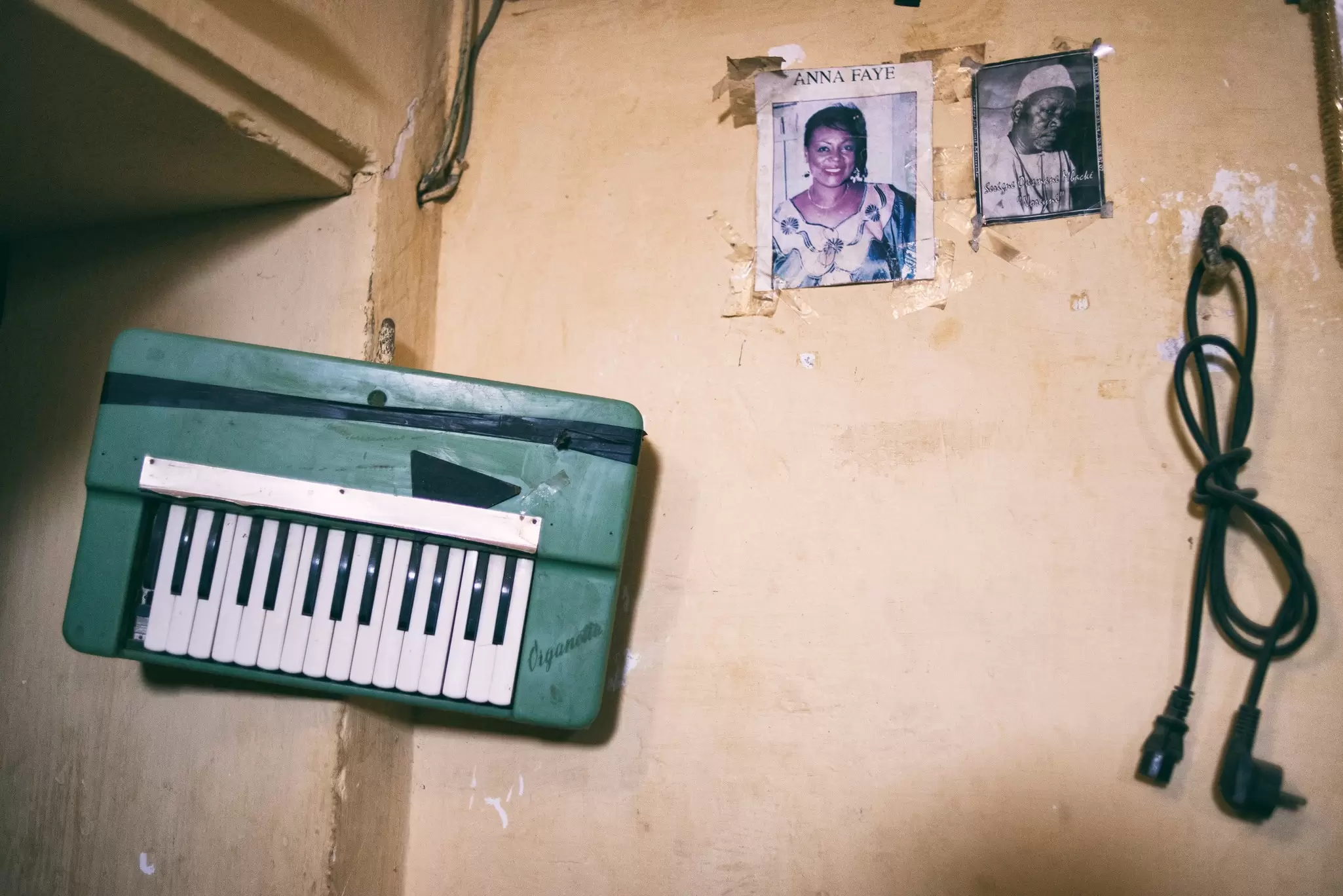 A wall in Civil Society's rehersal space, replete with old gig posters, on Île de Gorée. Emmanuelle Andrianjafy / Lonely Planet