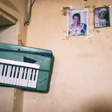 A wall in Civil Society's rehersal space, replete with old gig posters, on Île de Gorée. Emmanuelle Andrianjafy / Lonely Planet