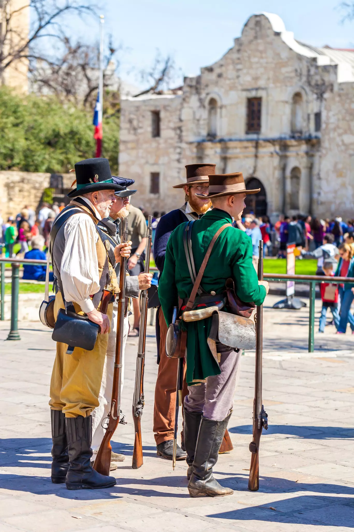 Men dressed as 19th-century soldiers participate in a reenactment of the Battle of the Alamo in San Antonio, Texas.
