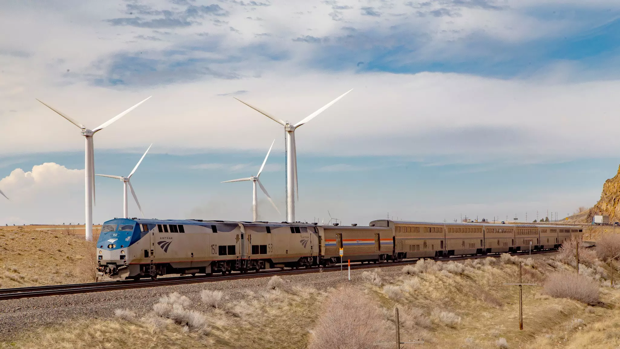 A train passing over raised tracks by wind