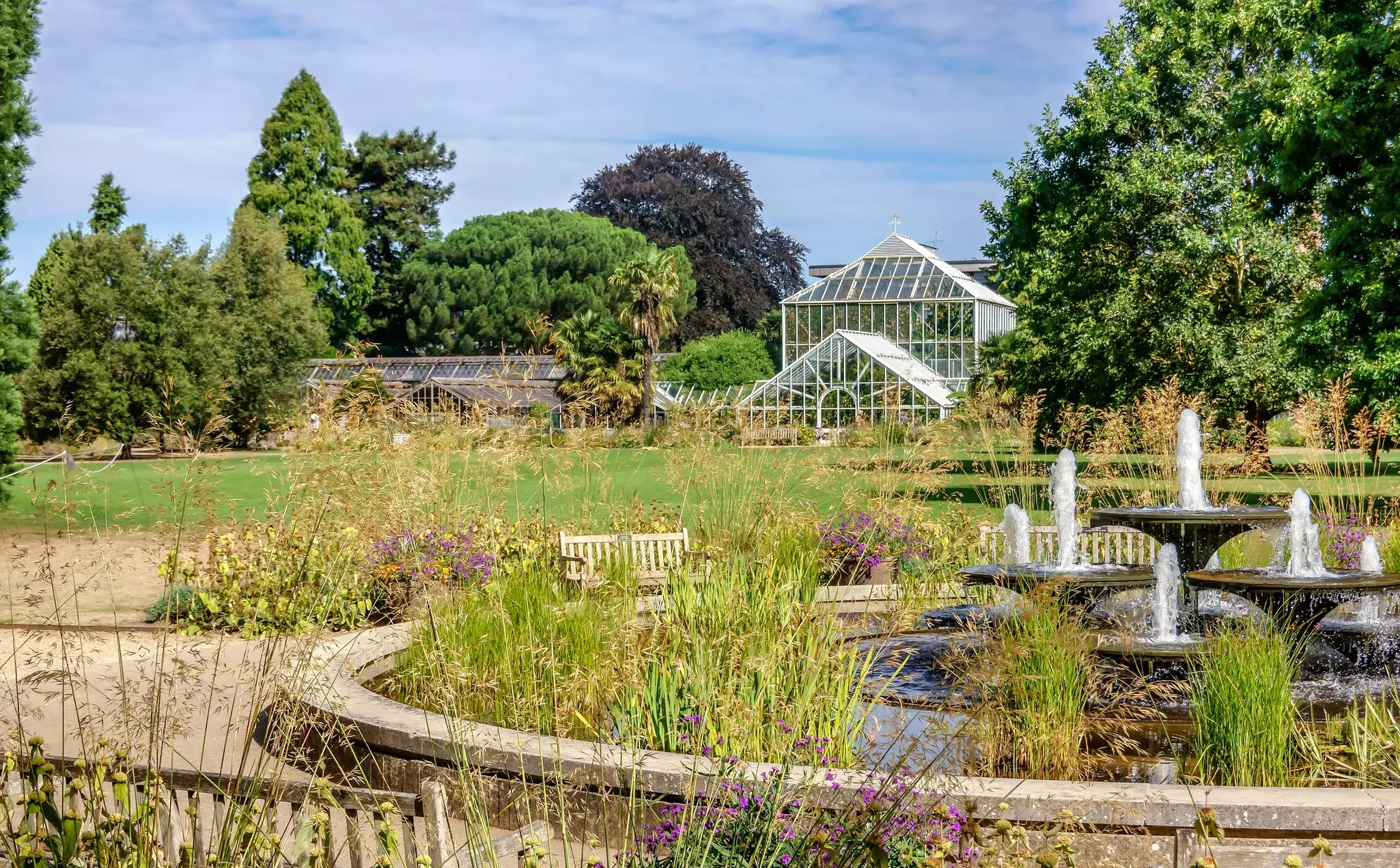 View of the fountain and greenhouses in the Cambridge University Botanic Garden, Cambridge, England.