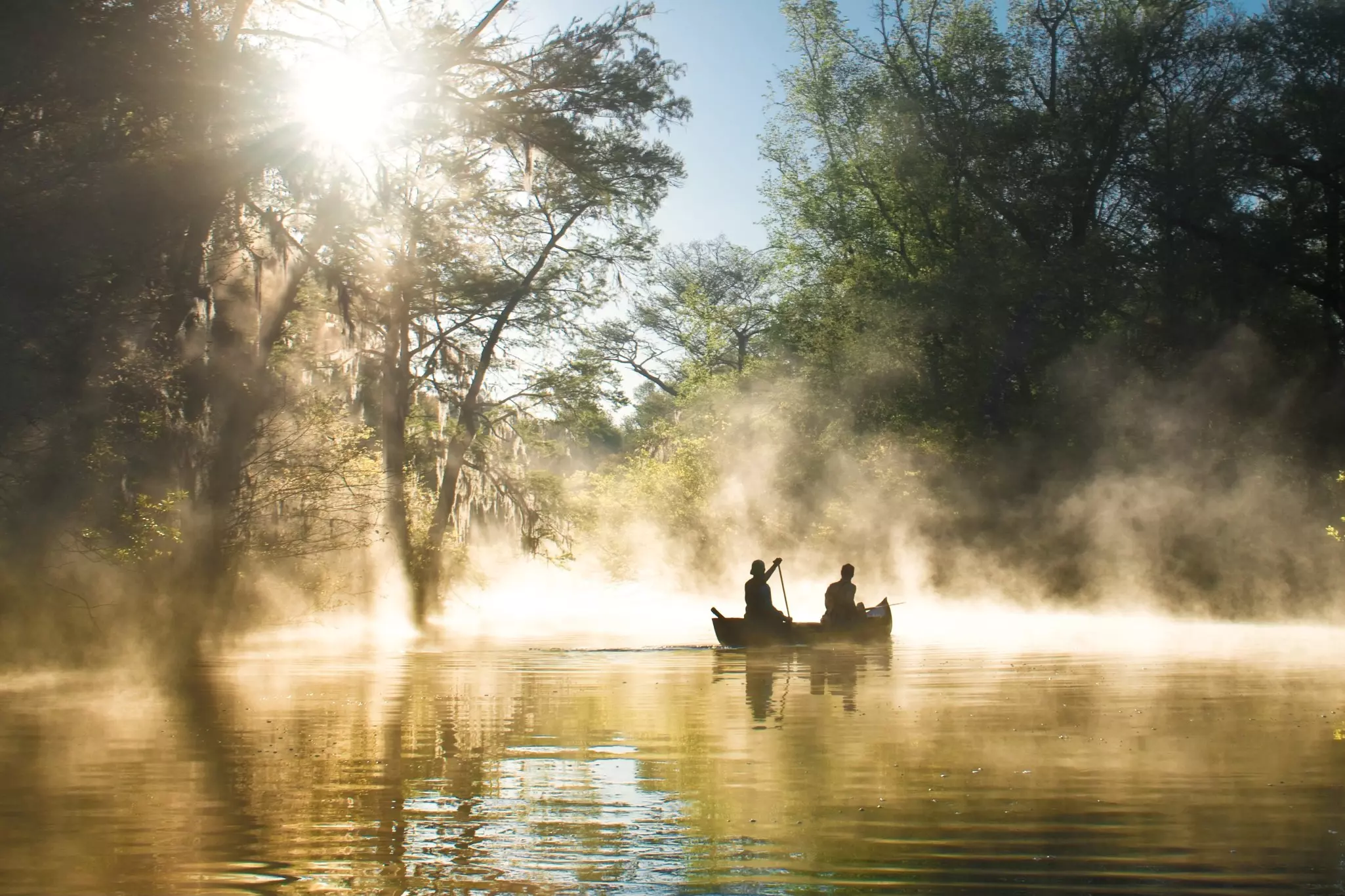 Two people canoeing in the mist at Everglades National Park