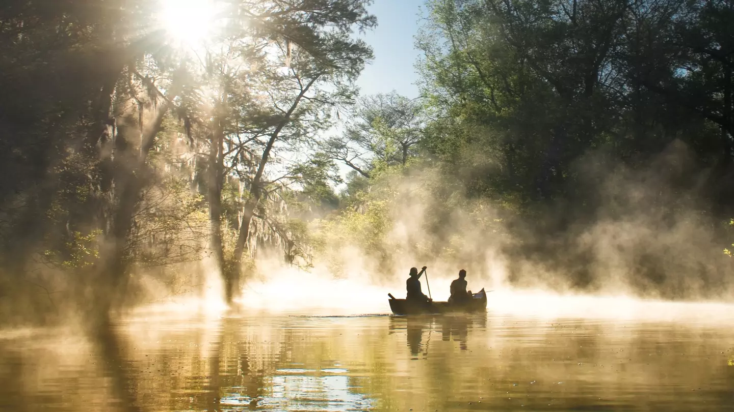 Two people canoeing in the mist at Everglades National Park