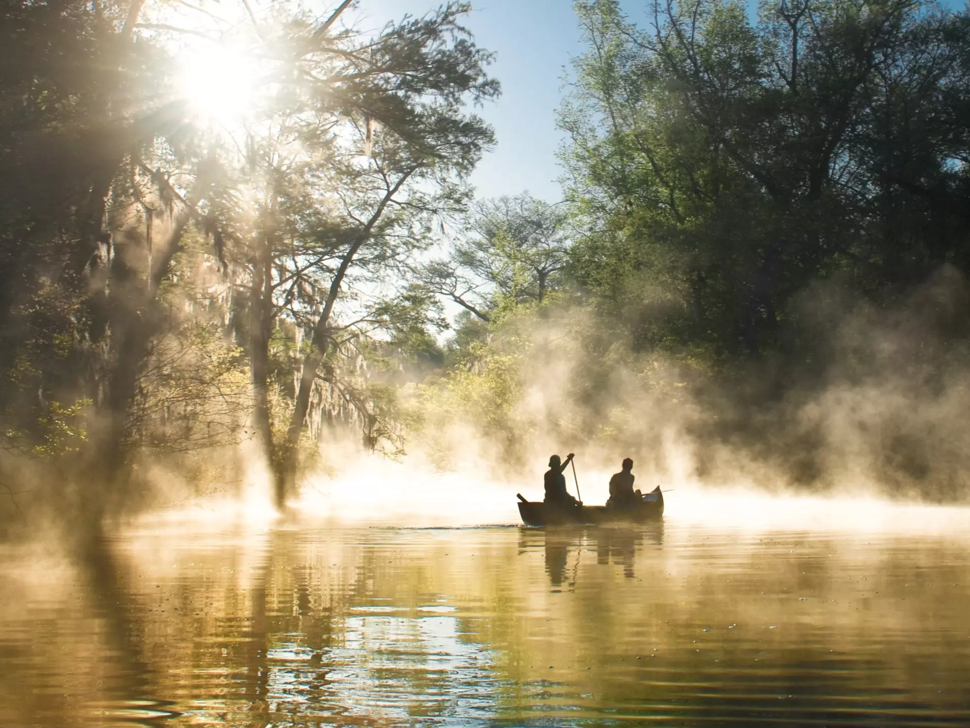 Two people canoeing in the mist at Everglades National Park