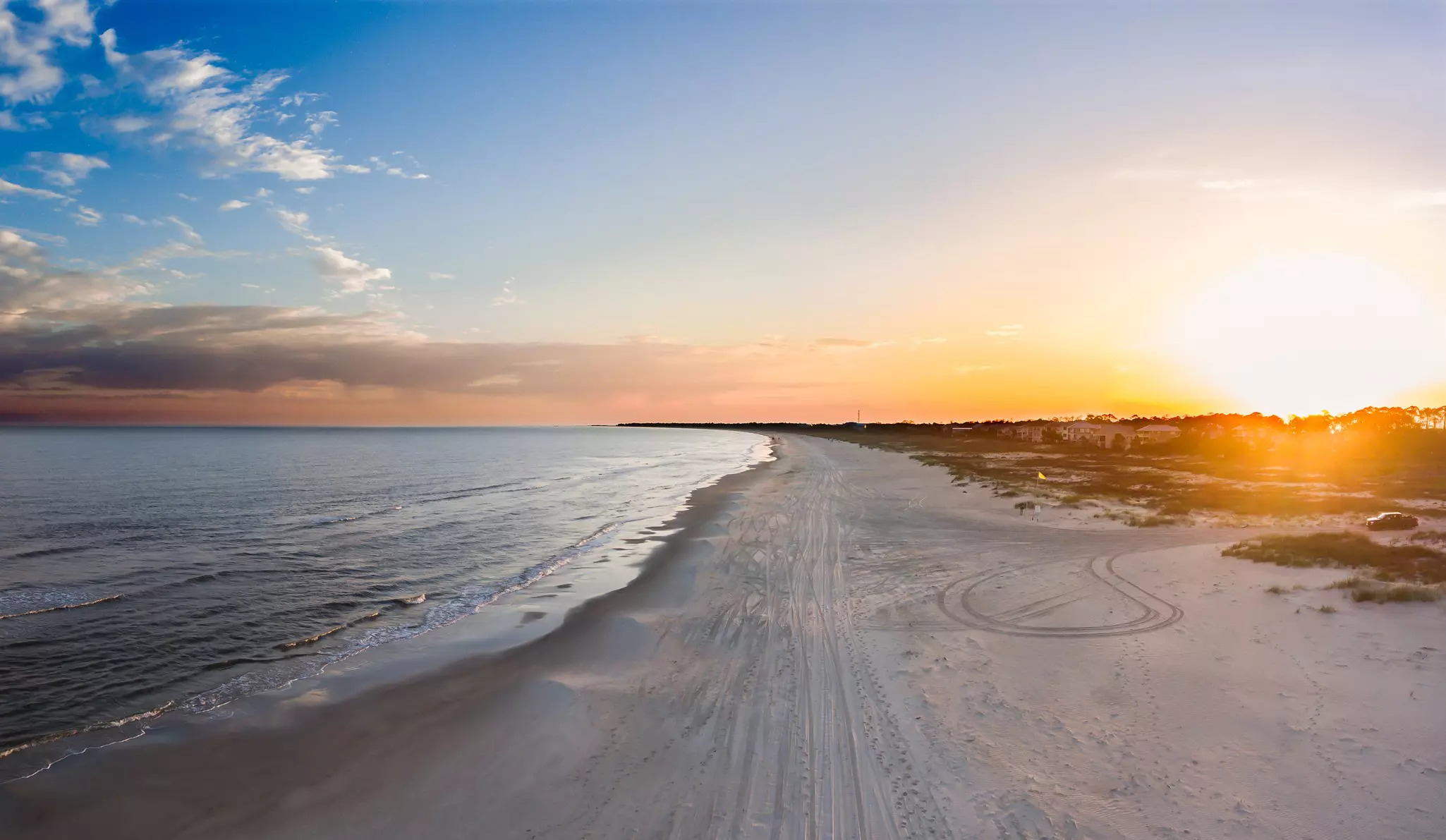 Aerial landscape of an ocean and beach at sunset,