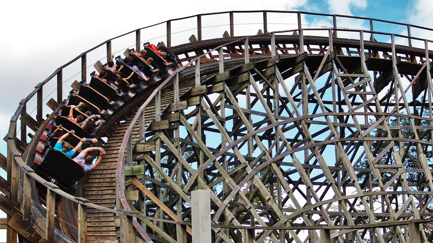 People with their hands up inside a looping wooden roller coaster in Dollywood