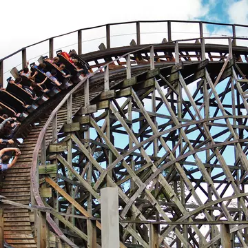 People with their hands up inside a looping wooden roller coaster in Dollywood