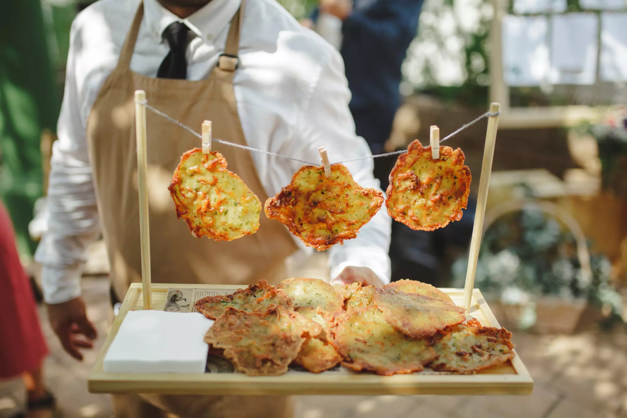 Shrimp fritter on sale, with three of them pegged on a line, during Carnaval in Cadiz.