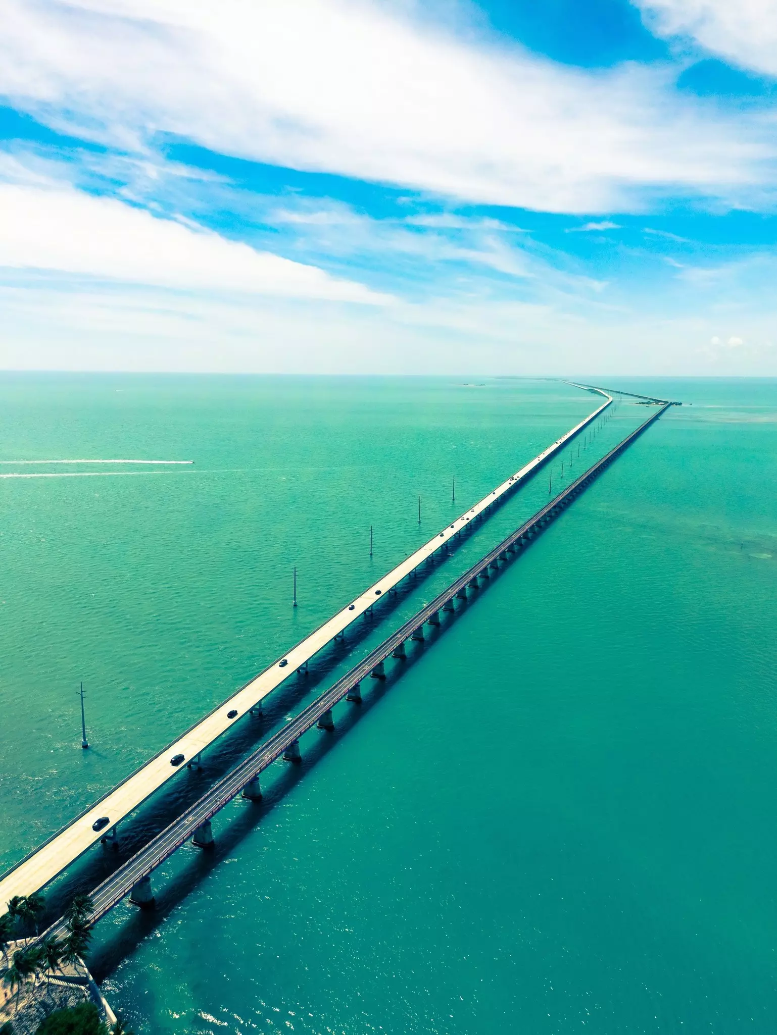 An aerial view adjacent bridges, a wide one for motor vehicles and narrower one for pedestrians and cyclists