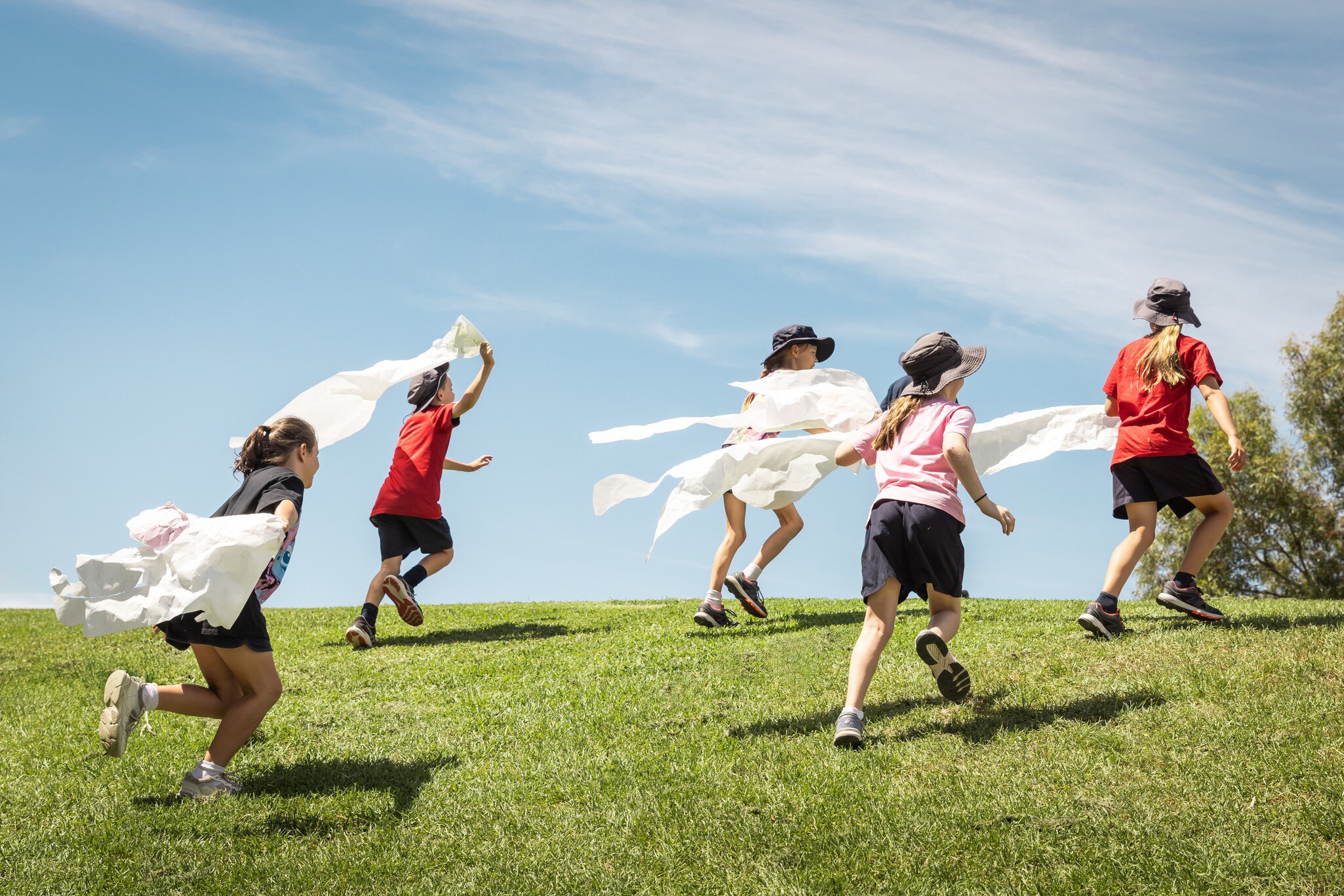 Kids running on the grass at ArtPlay in Melbourne, Australia. 