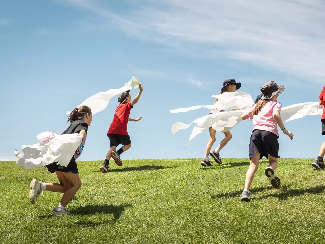 Kids running on the grass at ArtPlay in Melbourne, Australia. 