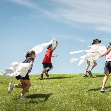Kids running on the grass at ArtPlay in Melbourne, Australia. 
