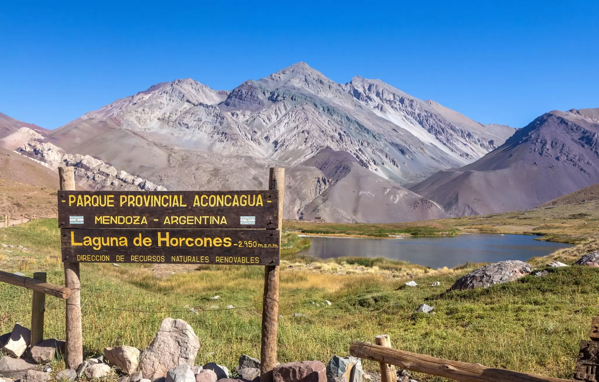 View of a sign by the Laguna de Horcones in the Parque Provincial Aconcagua in Argentina.