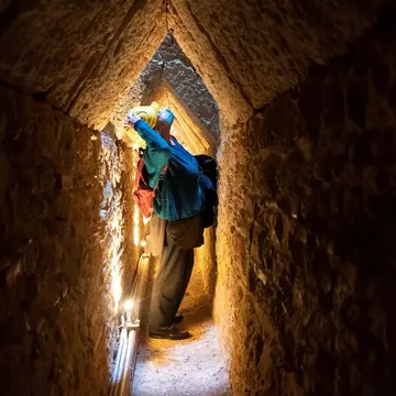 Photo taken on April 18, 2022 shows a visitor in the Tunnel of Eupalinos, which is situated in Samos, an island in the eastern Aegean, Greece. The Tunnel of Eupalinos is a water pipeline running through Mount Kastro in Samos, built in the 6th cent...